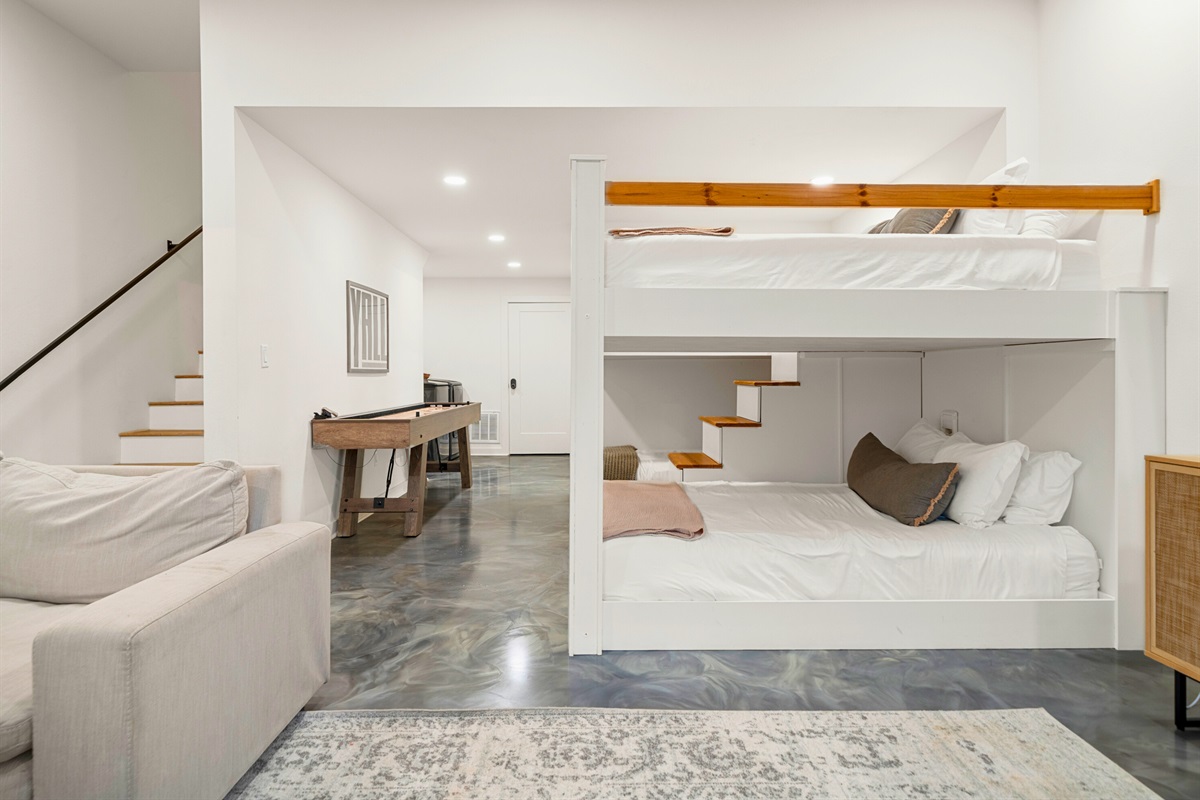 Lower-level hangout area with sleeper sofa and easy access to the game space.