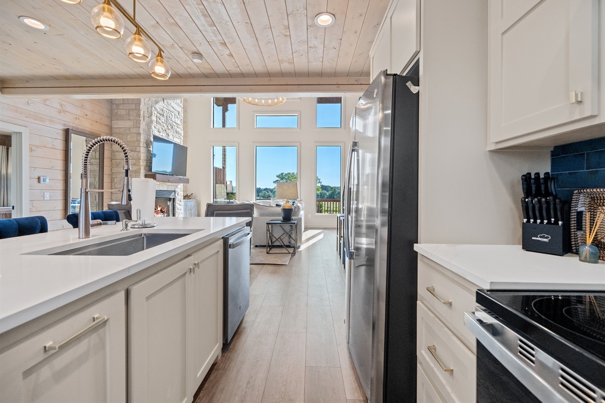 Kitchen with modern appliances and open layout flowing into the living room.