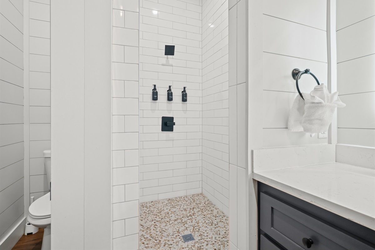 Clean lines and bright tile give this shower a crisp, updated feel that makes it easy to refresh and relax.