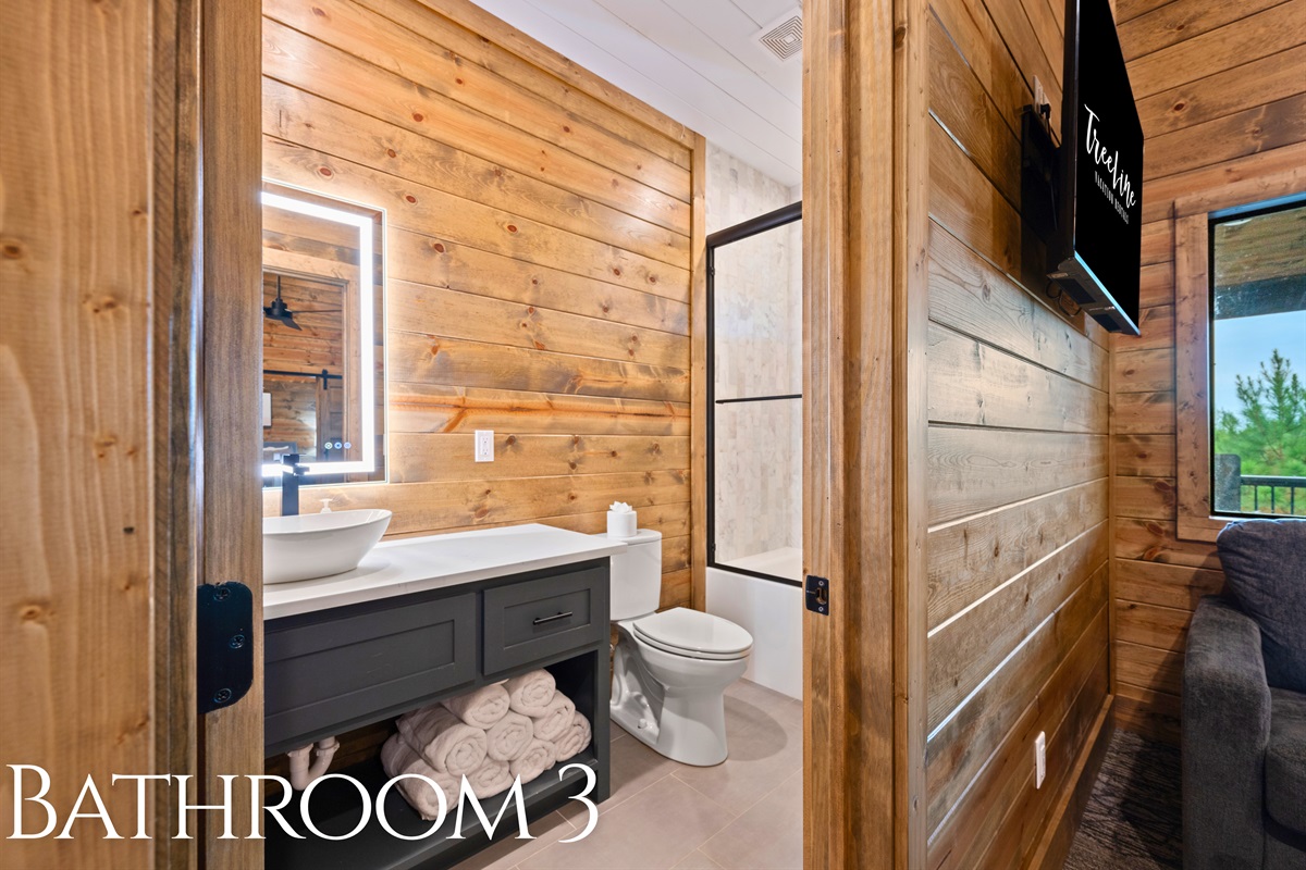 Bathroom 3 with modern vanity and rustic wood touches.