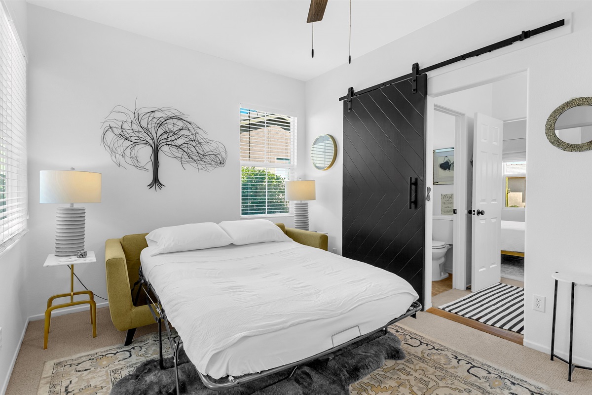 Chic guest suite with a convertible sofa bed and contemporary desert-inspired touches.