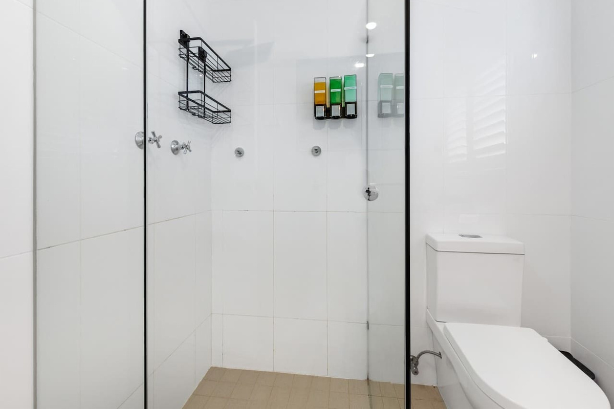 This upstairs main bathroom includes the shower and toilet for the upper level, close to the main bedrooms and living spaces.