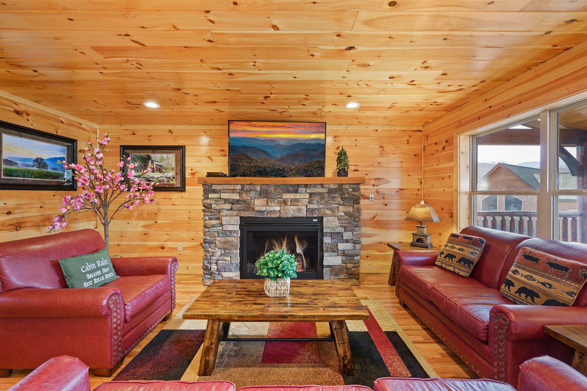 Living room on main level with fireplace and flat screen TV