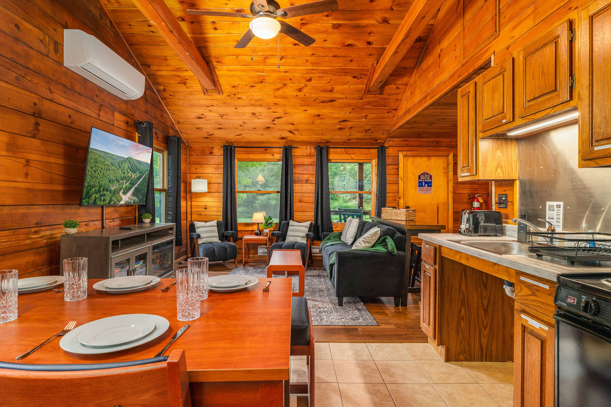 🍳 Open kitchen + dining with forest views in every direction.