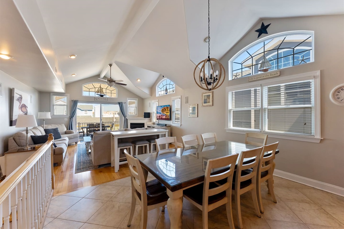 Spacious and bright open concept dining area with main dining table for 8, bar with 3 additional stools inside of the beautiful eat-in kitchen. 