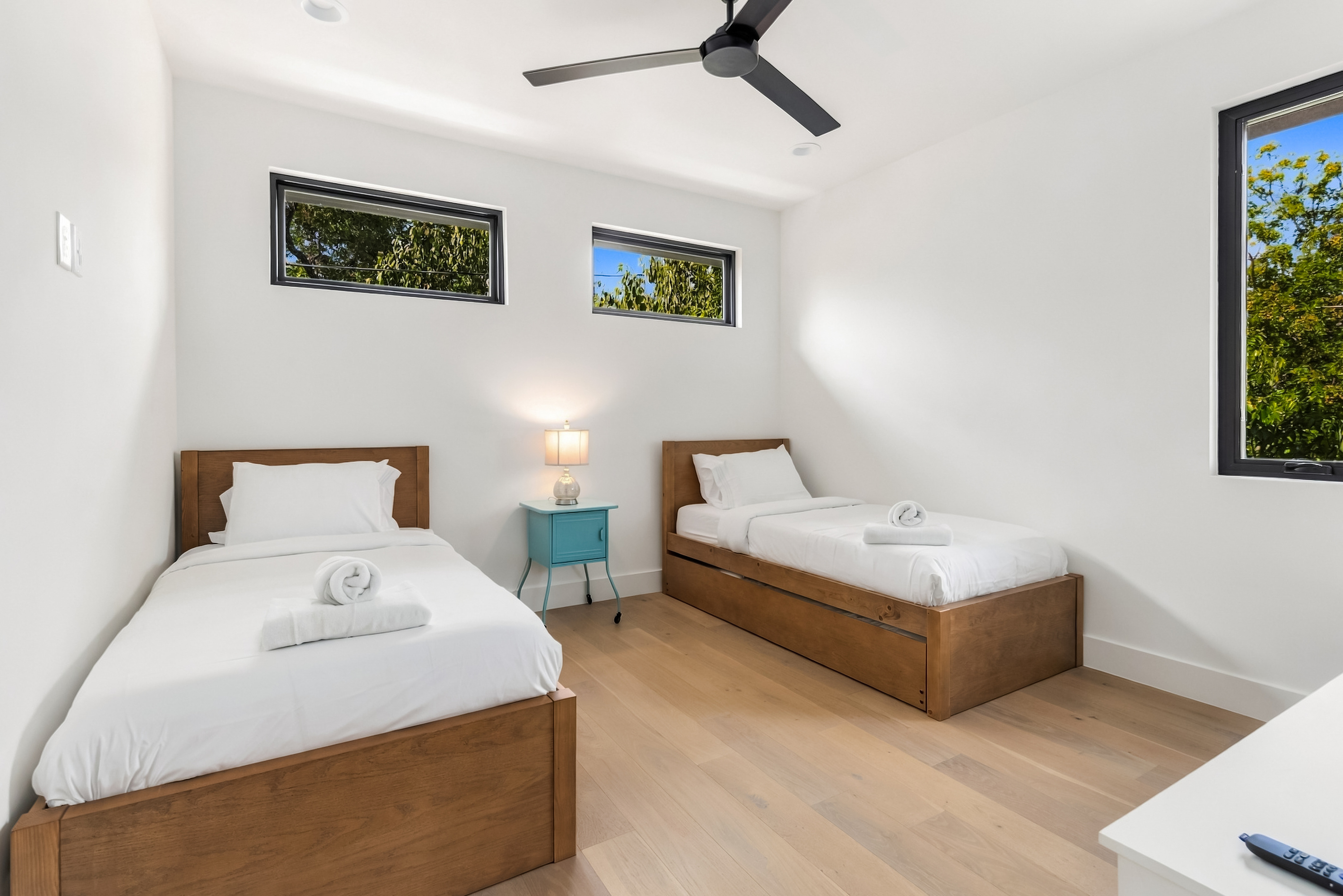 Twin beds, 1 with a pull out, a shared nightstand — comfortable space for three