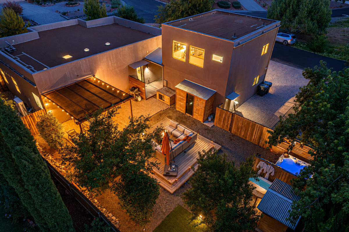 {Property at Dusk} Your private Sedona retreat glows after sunset, with multiple outdoor spaces designed for gathering and relaxing.