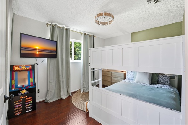 Spacious full-over-full bunk bed with twin trundle (lower bed suitable for toddlers). In-room TV and classic arcade game for entertainment. Includes dresser and closet space for easy storage. Changing pad available upon request. 