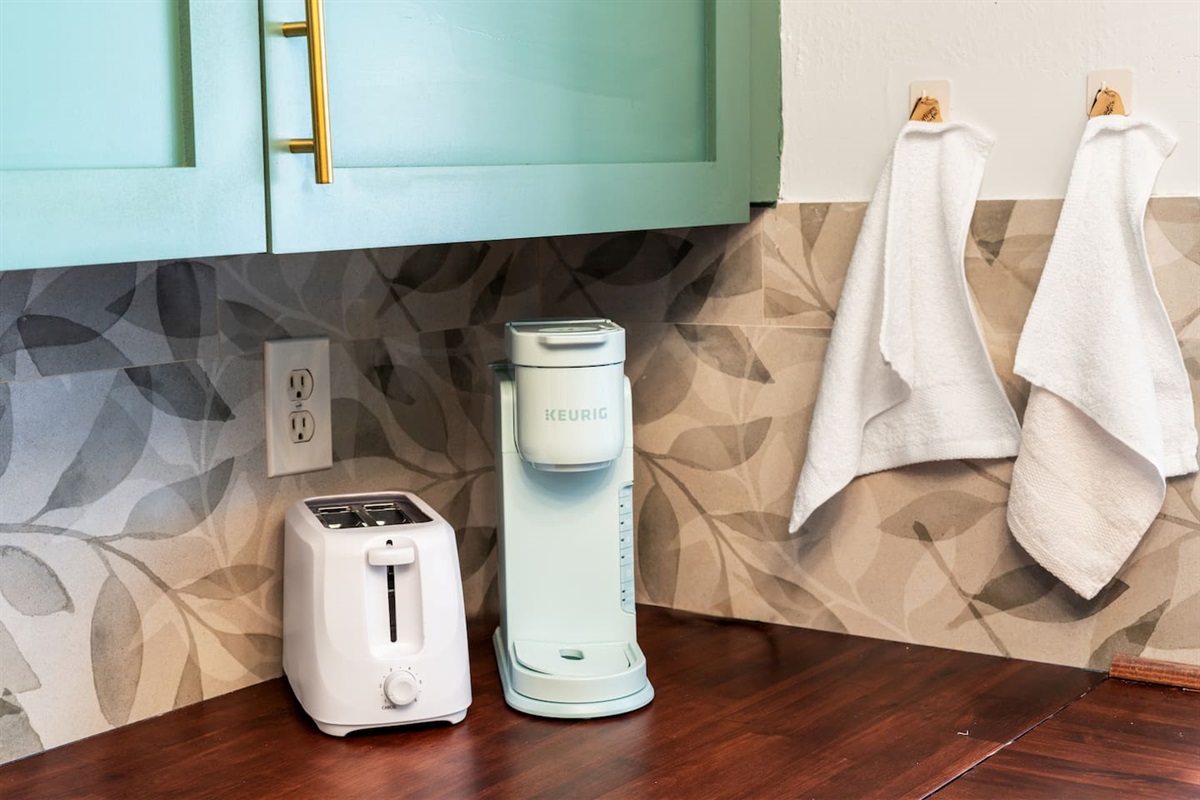 Full kitchen with utensils, toaster, coffee maker, and more.