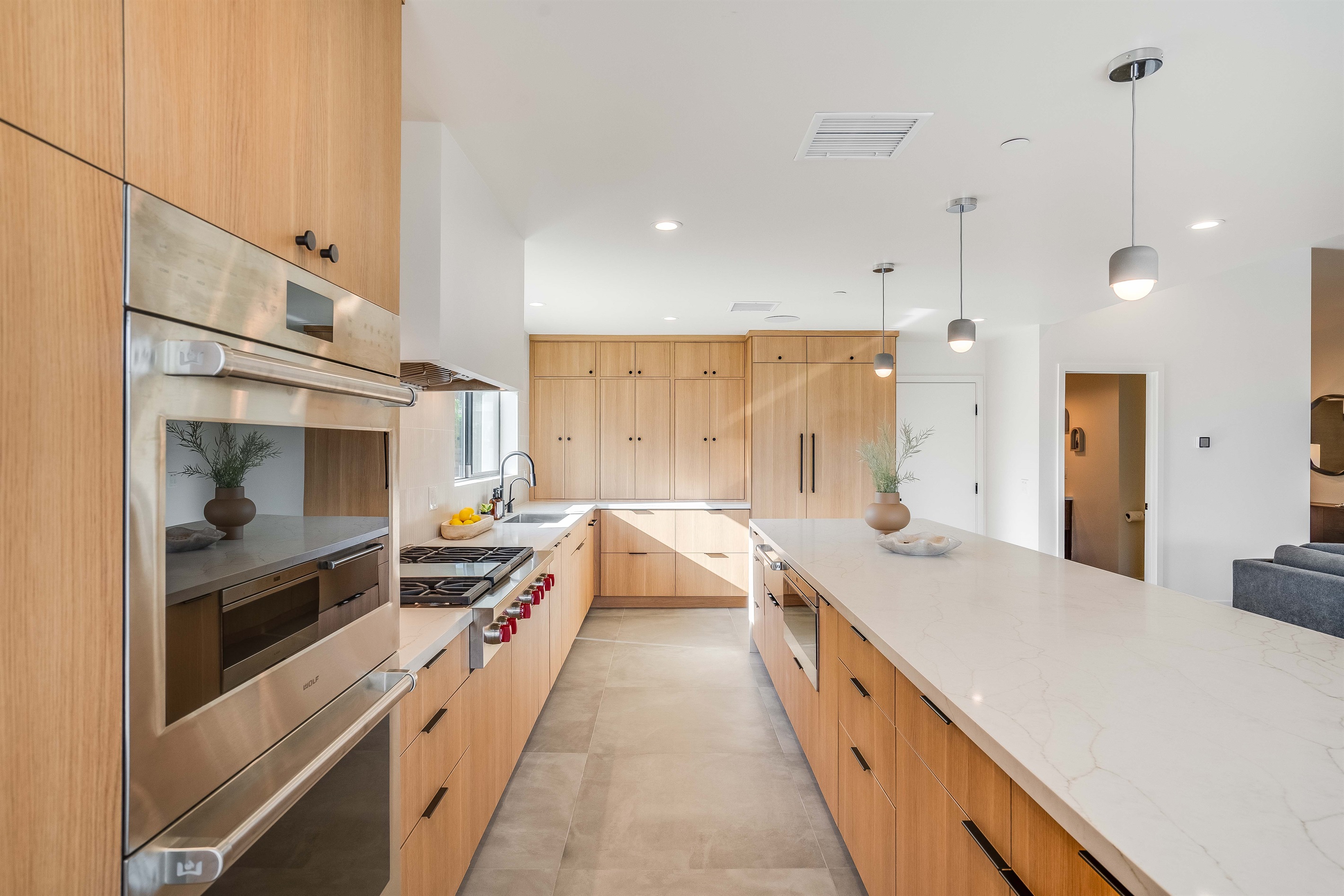 Chef's kitchen equipped with Subzero panel refrigerator/freezer and Wolf appliances including 6-burner range-top and infrared griddle, Professional Series built-in double-ovens, warming drawer