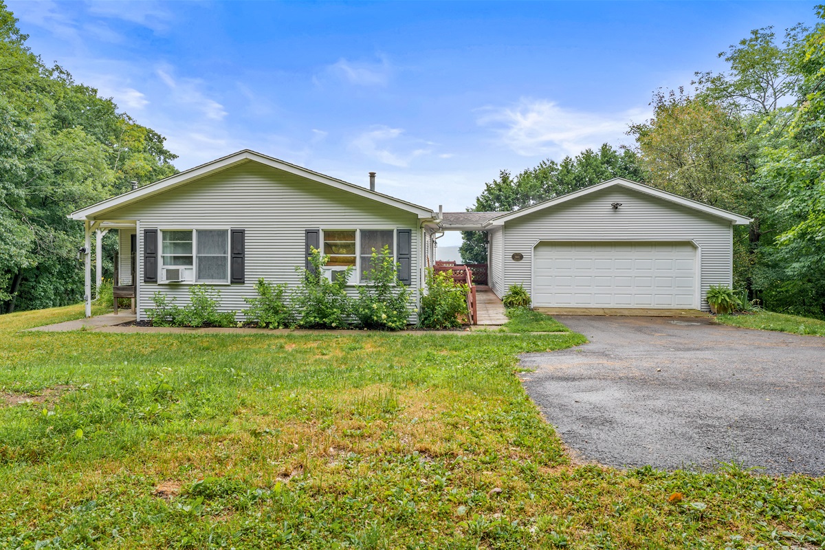 Tucked into the trees, this inviting ranch offers a peaceful escape with a private driveway and attached garage