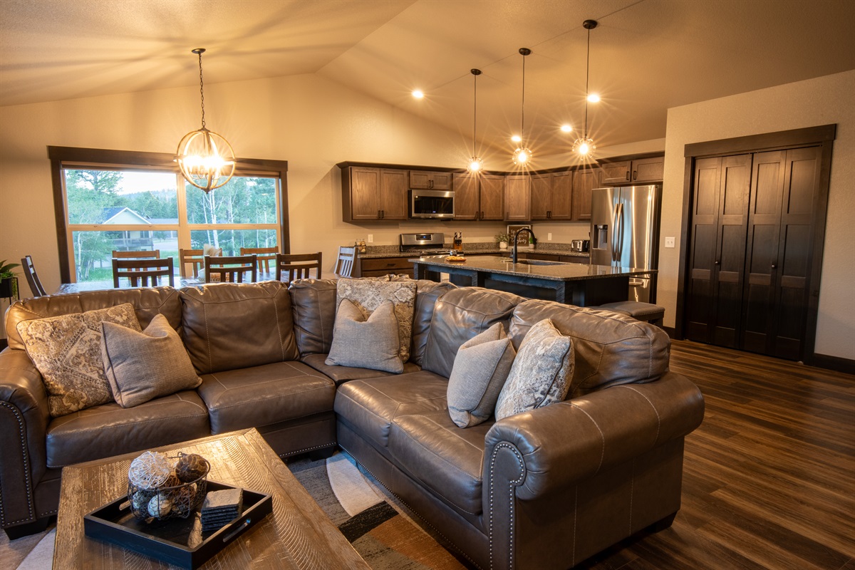 Envision lounging on the luxurious leather sectional at "On The Rocks," soaking in the open layout that flows into a modern kitchen and dining area.