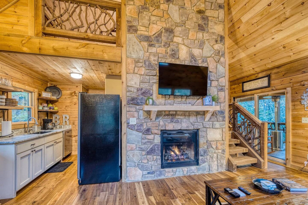 Enjoy a view of our TV area, with a glimpse of the adjacent kitchen, where the heart of our home beats with both savory delights and captivating entertainment