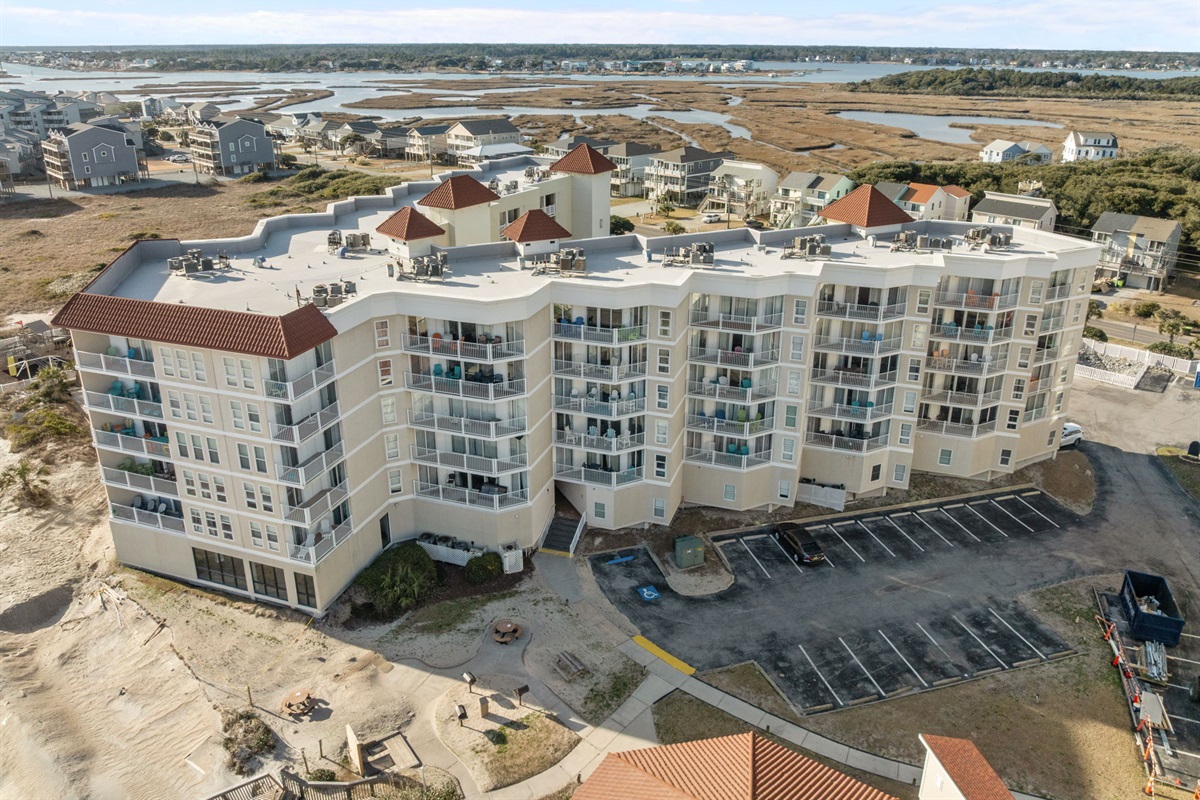 Exterior view of St. Regis Building 1, showcasing multi-level balconies and sound marshlands


