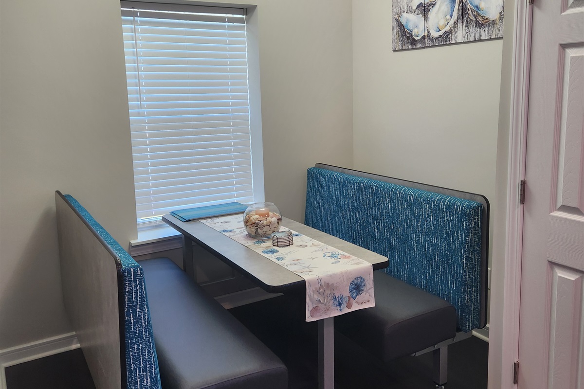 Tucked away just off the kitchen, this cozy dining booth is the perfect spot for morning coffee, casual meals, or evening board games