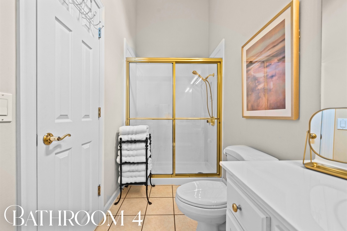 Bathroom 4: Elegant with gold trim and a bright, cheerful glow.