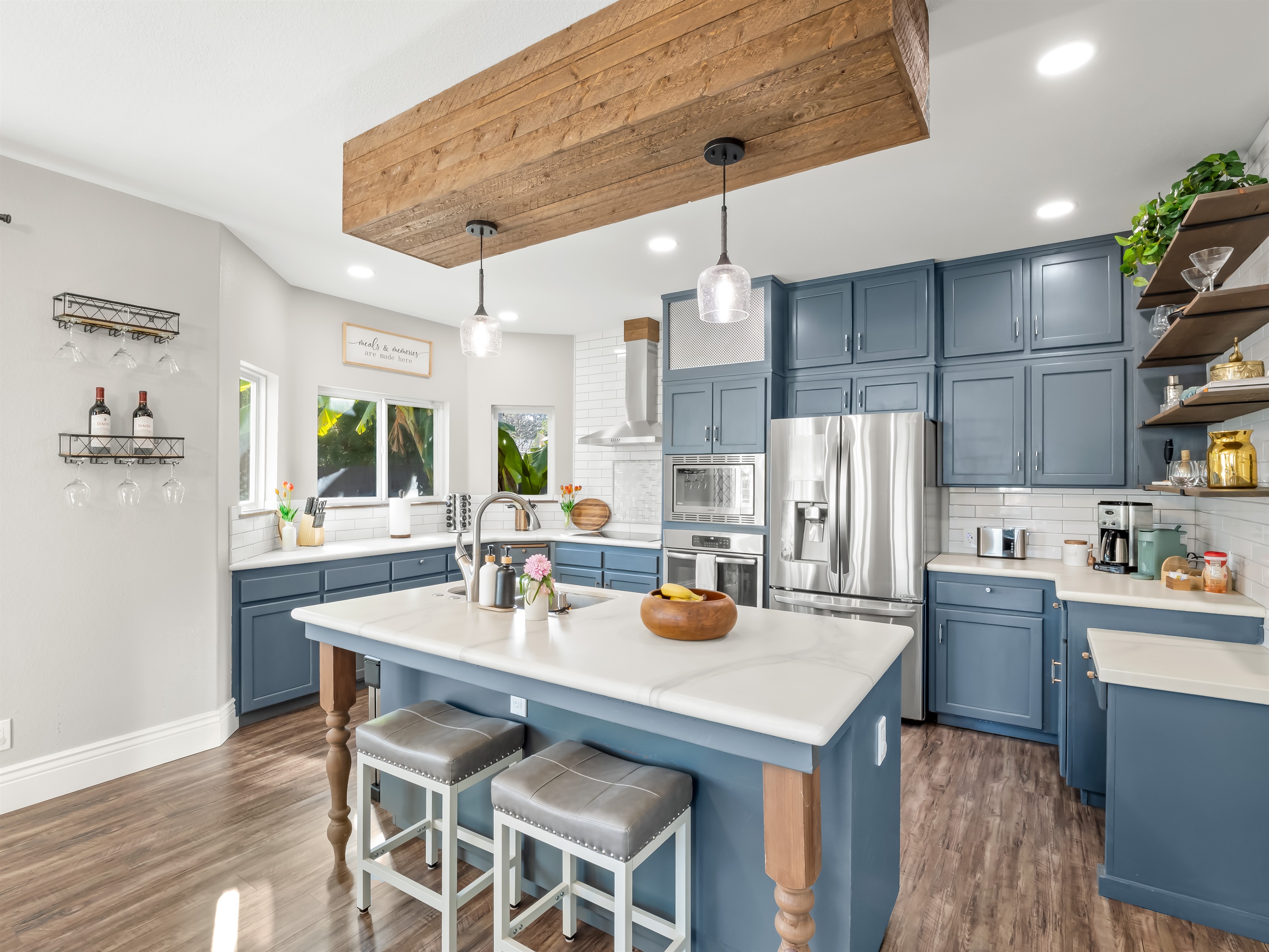 Fully stocked kitchen with stainless steel appliances, spacious island seating, coffee maker, toaster, and all the essentials needed to prepare family meals with ease.