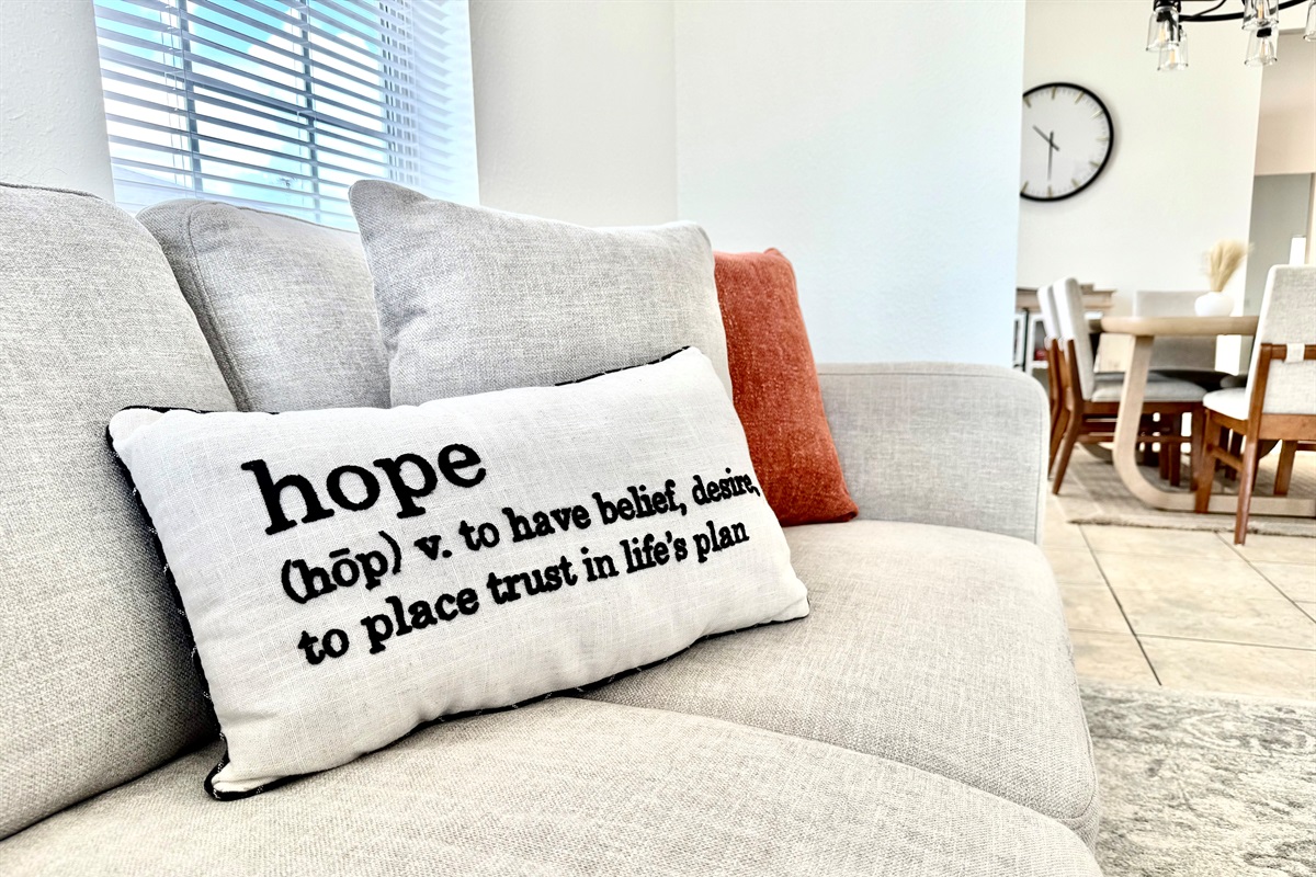 With two large sofas, warm accent pillows, and a classic coffee table setup, it's the perfect spot for family movie nights or laid-back mornings with coffee.