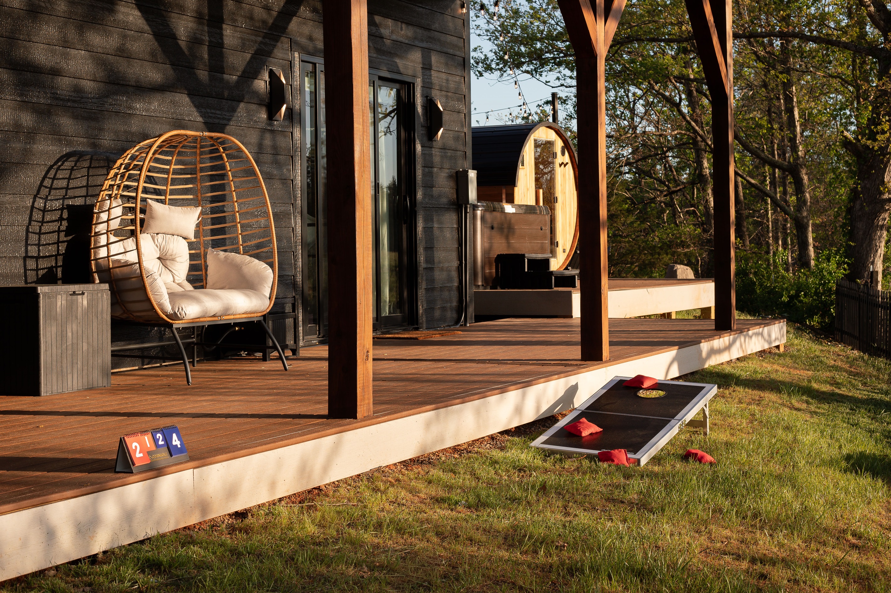 {Covered Porch + Outdoor Games}
Challenge your group to a friendly game of cornhole, unwind in the hanging chair, or simply enjoy the fresh mountain air from the covered porch. Easygoing outdoor moments start here.