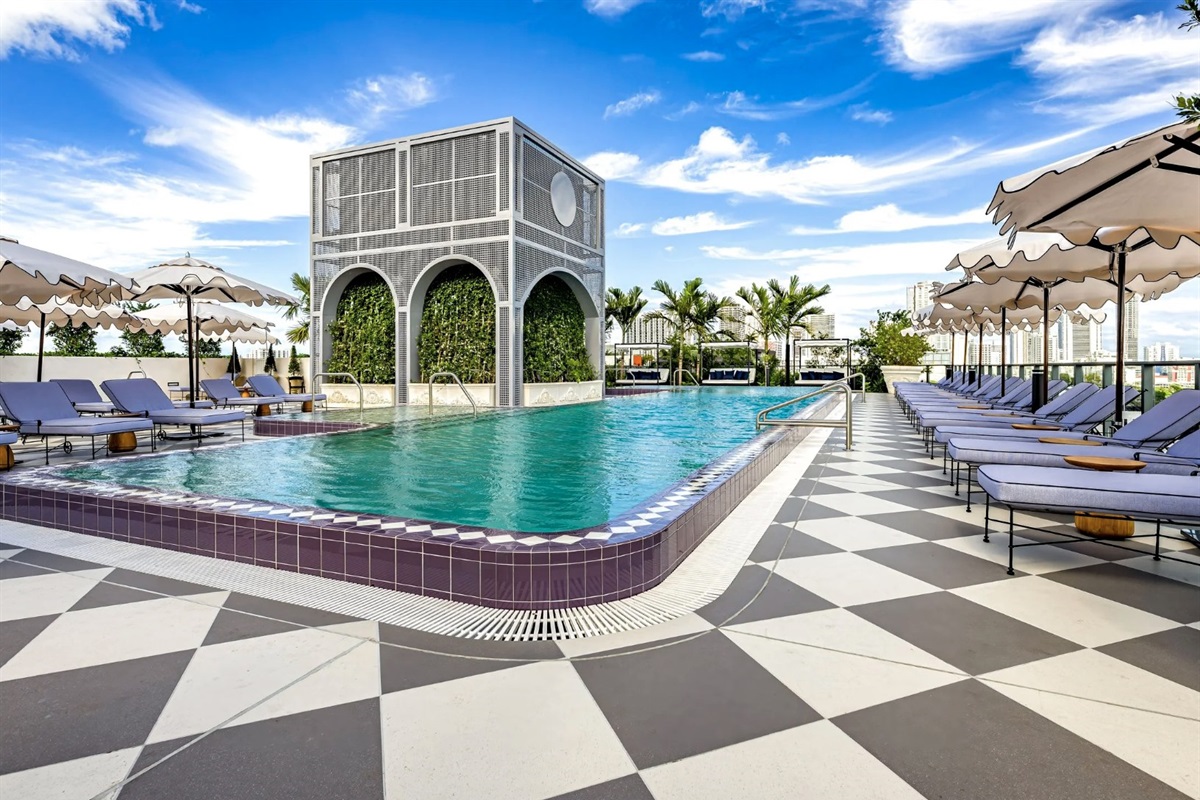 Rooftop pool deck &mdash; loungers, white umbrellas and signature arched cabana