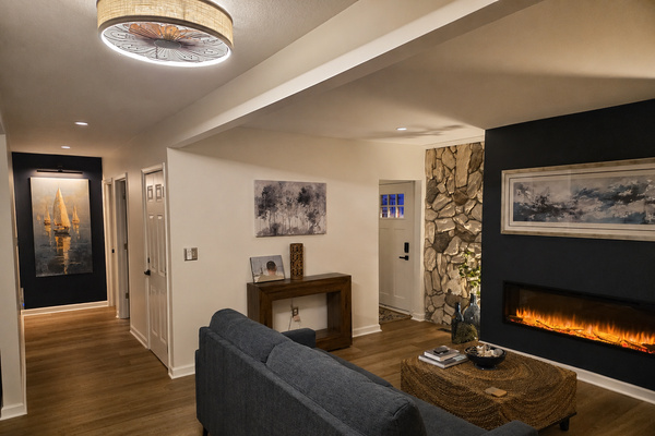 Cozy main-floor living room with a fireplace, stone accent wall and comfortable seating for relaxing after a day at the lake.