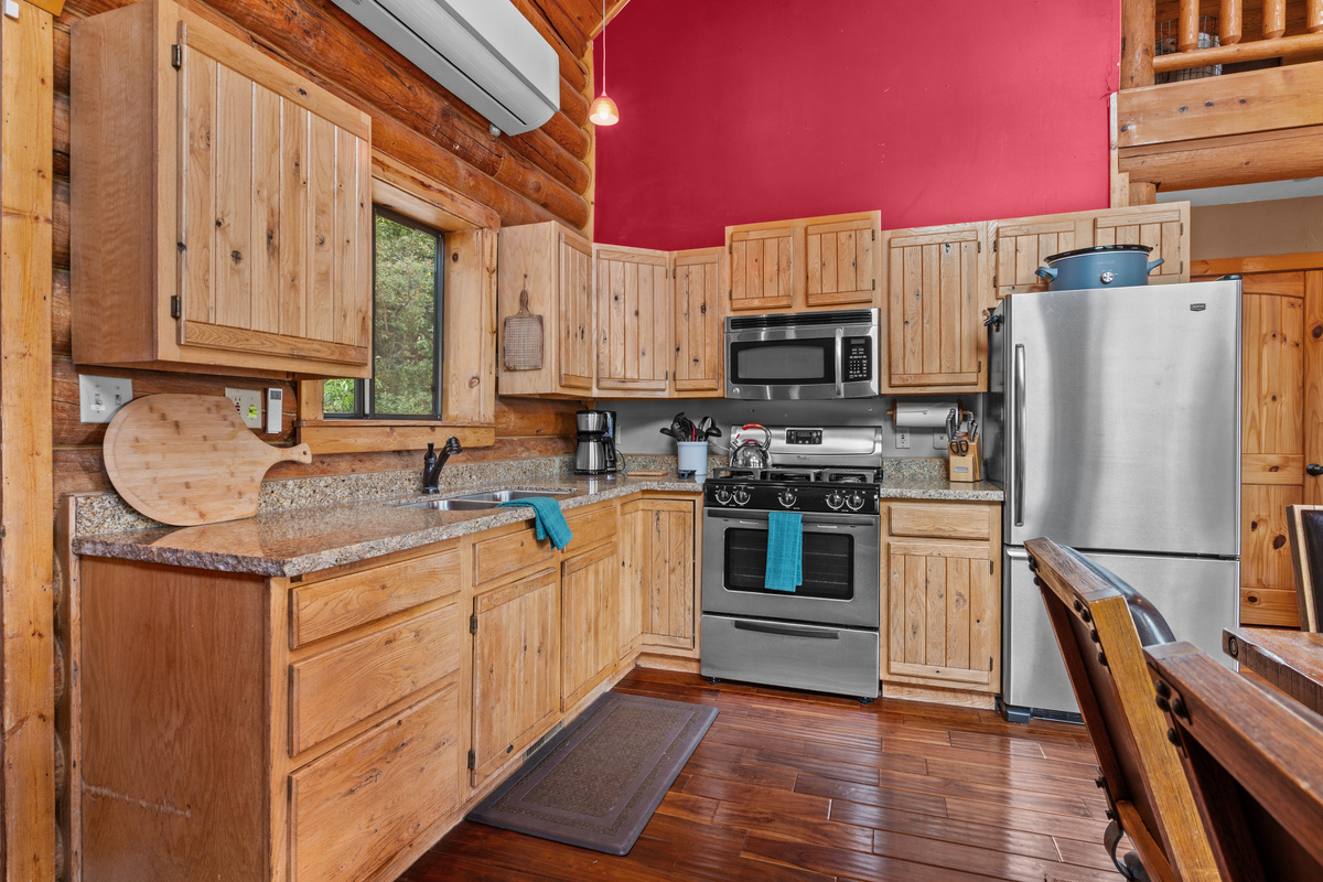 Fully equipped kitchen with gas stove, stainless appliances, and generous cabinet space.