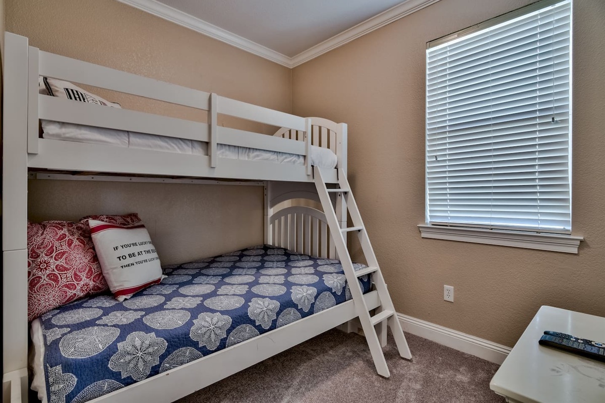 BEDROOM #6- 3RD FLOOR BUNK ROOM (Twin over Full bunk room, features a dresser and a TV)