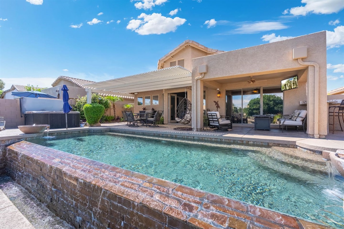 The pool's waterfall feature adds a gentle soundtrack to your afternoon — the kind of ambient detail that makes you forget about the rest of the world.