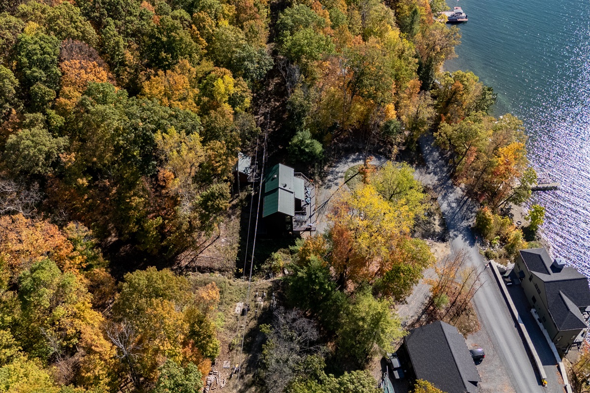 Side angle of the home near the shore — unwind where forest meets lake.
