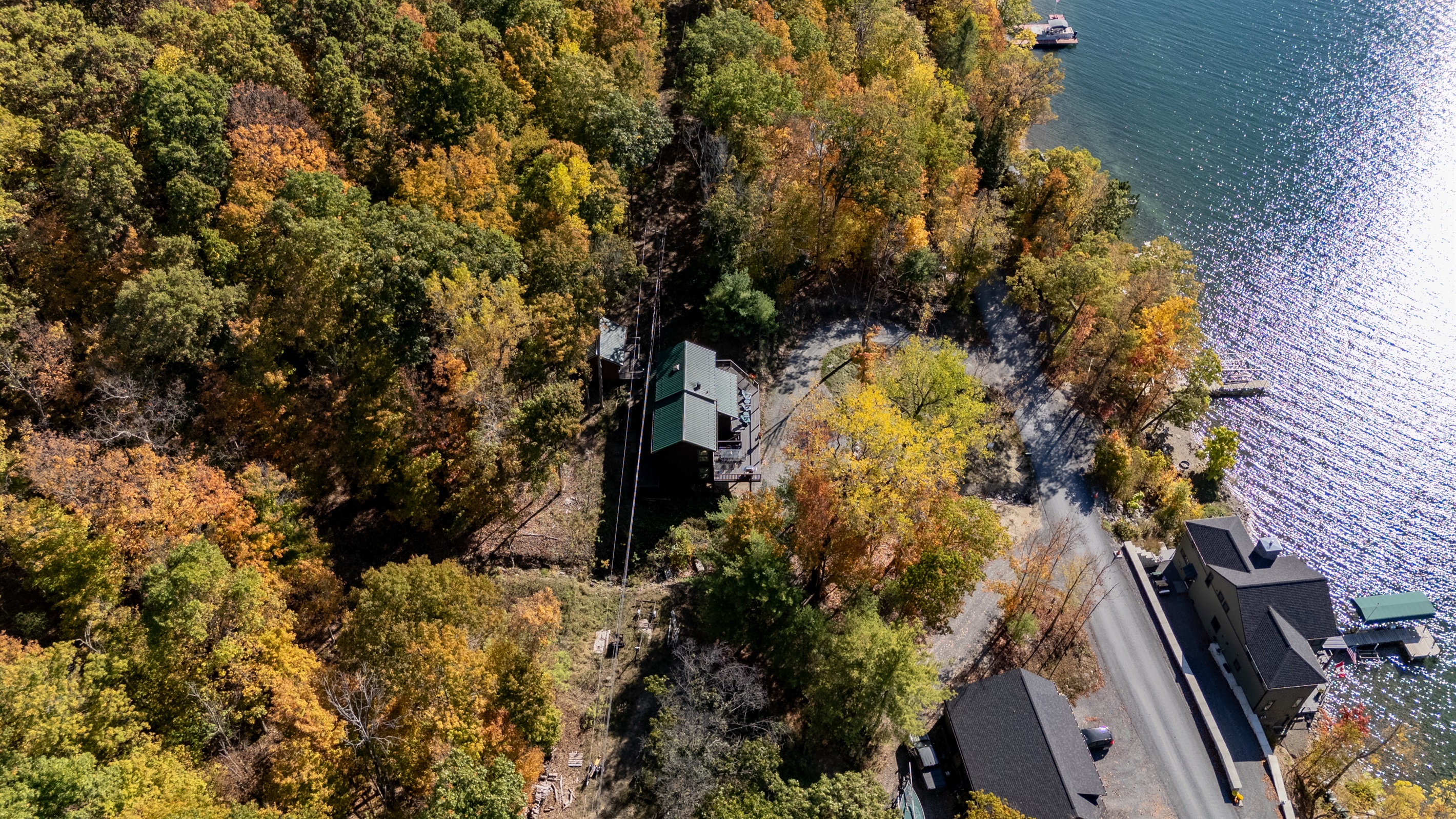 Side angle of the home near the shore — unwind where forest meets lake.