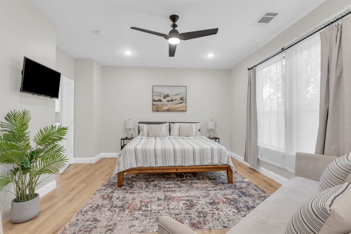 Master suite with neutral tones and stylish framed art.