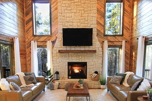 Relax by the indoor fireplace in a cozy living room designed for family comfort.