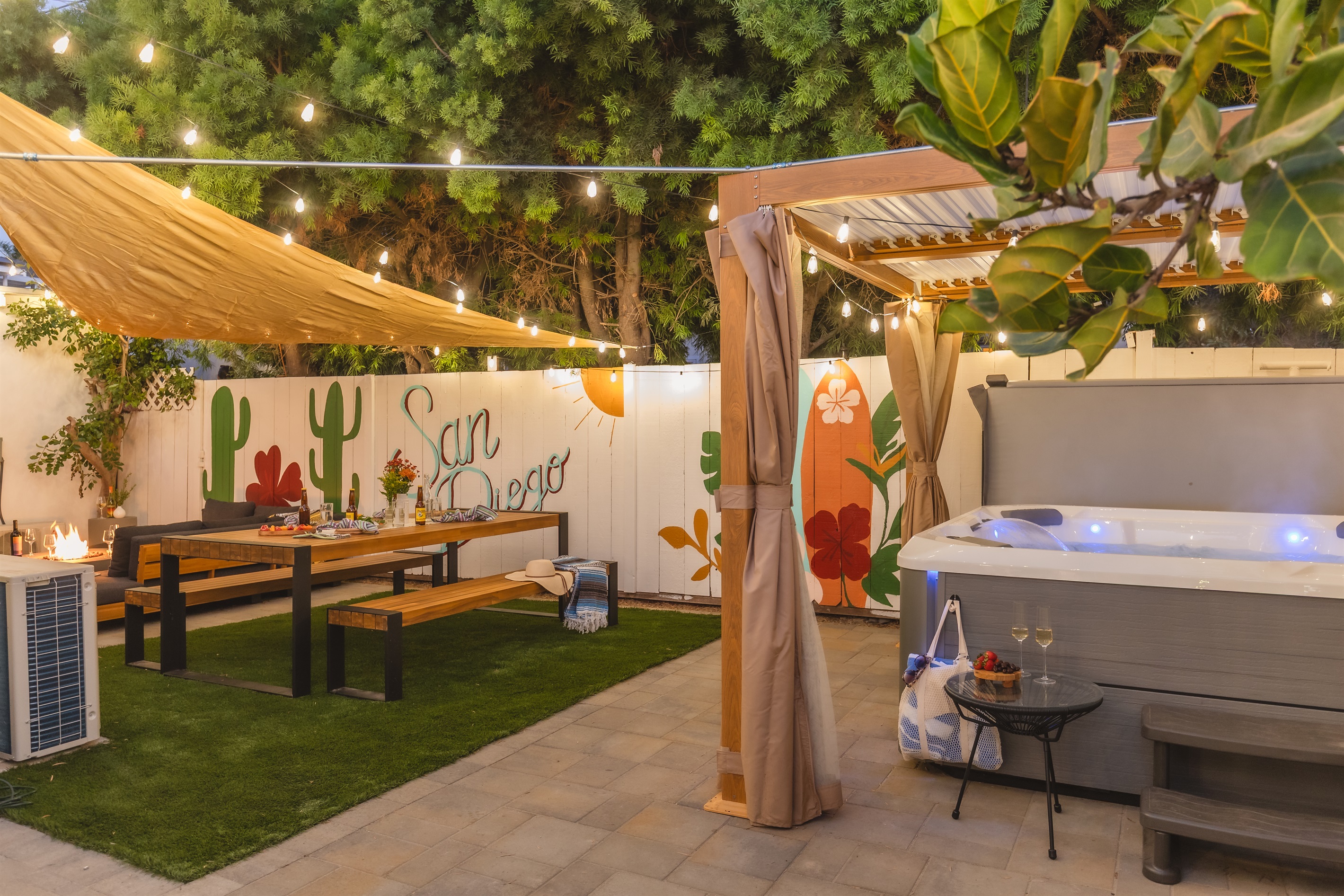 Unwind under the string lights in your private San Diego oasis, complete with a hot tub, fire pit, shaded dining area, and colorful mural vibes 🌵🍷✨