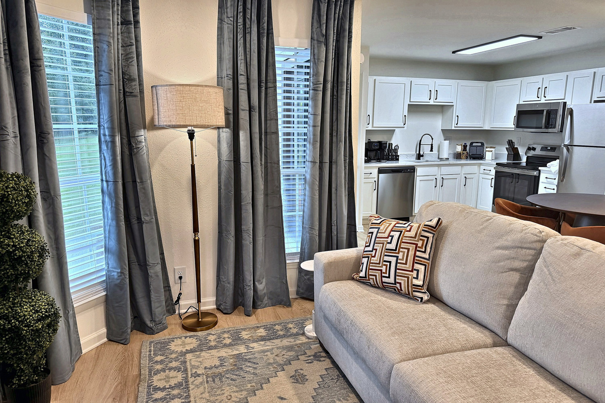 Open floor plan: sofa, dining table and kitchen in one bright space