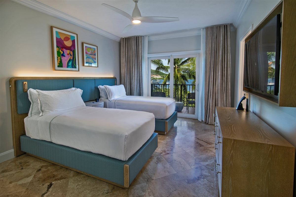 Guest bedroom with twin beds at the Ritz-Carlton Residences, St. Thomas, offering flexible sleeping arrangements in a luxury island condo.