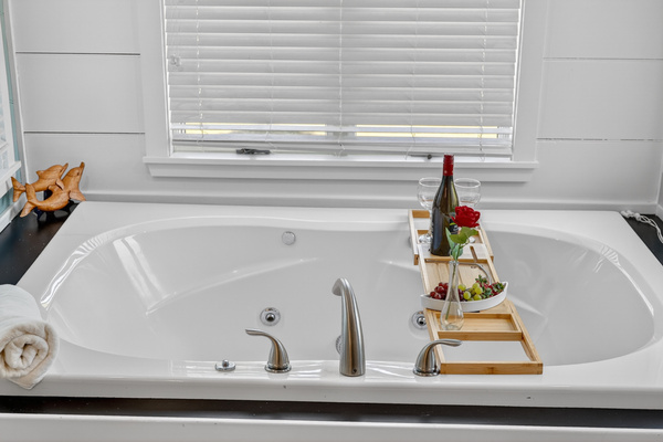 Spa-inspired bathroom featuring a soaking tub, double vanity, and plenty of storage for your stay.