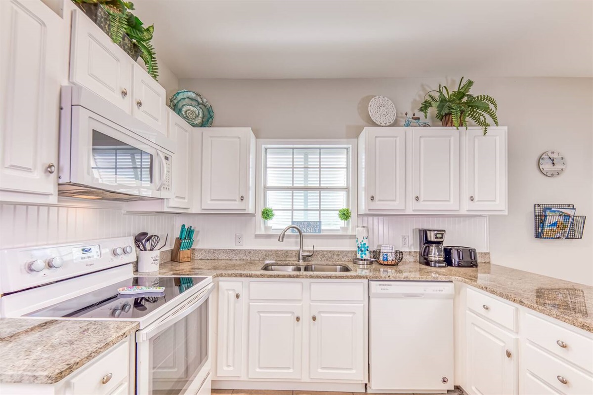 Kitchen: Bright and airy space with modern appliances and charming decor, perfect for culinary adventures!