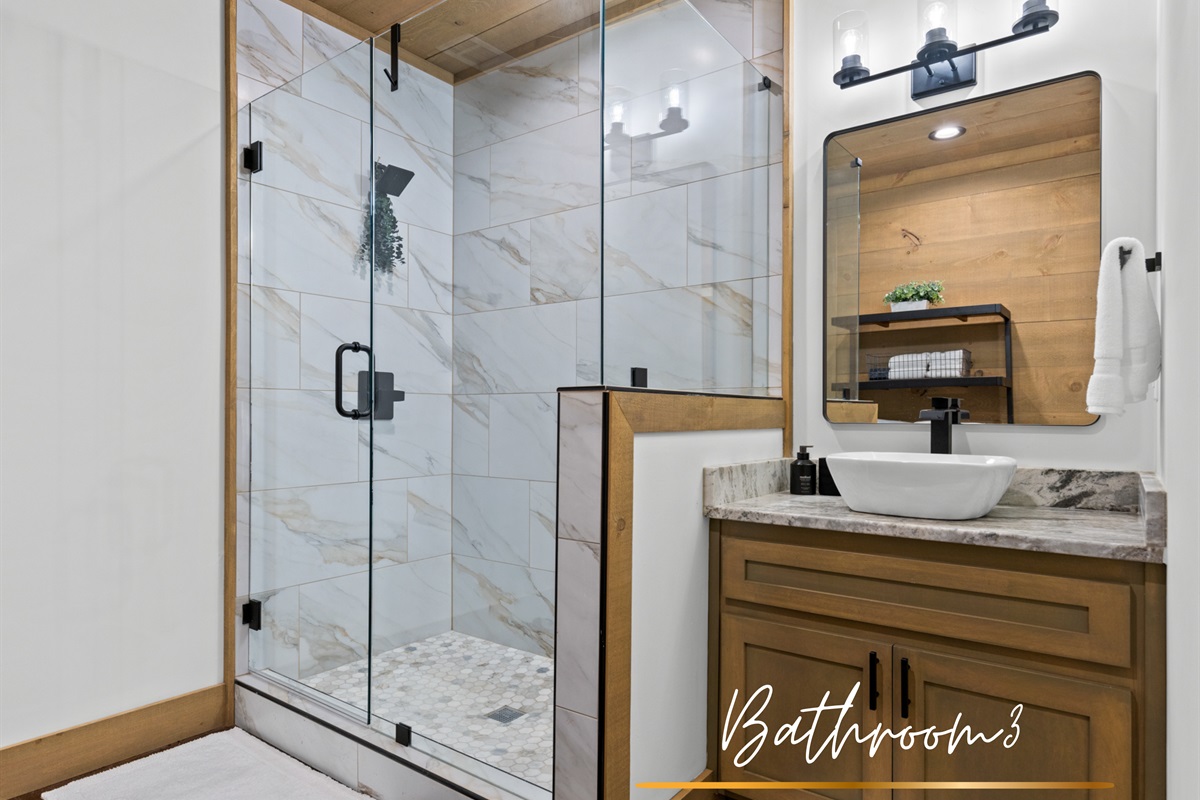 A private bathroom with a sleek vanity and a warm shower. Everything you need to refresh and relax.