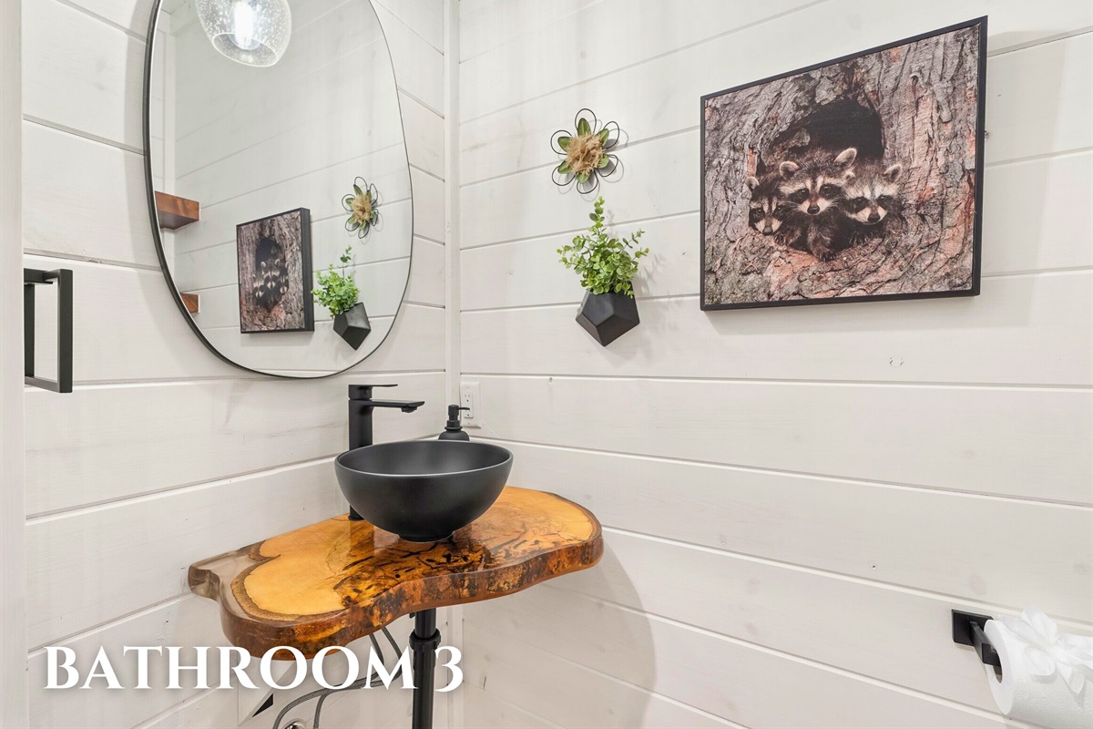 Bathroom with circular mirror and sleek fixtures.