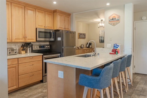 The kitchen is located near the coffee bar (in the background).
