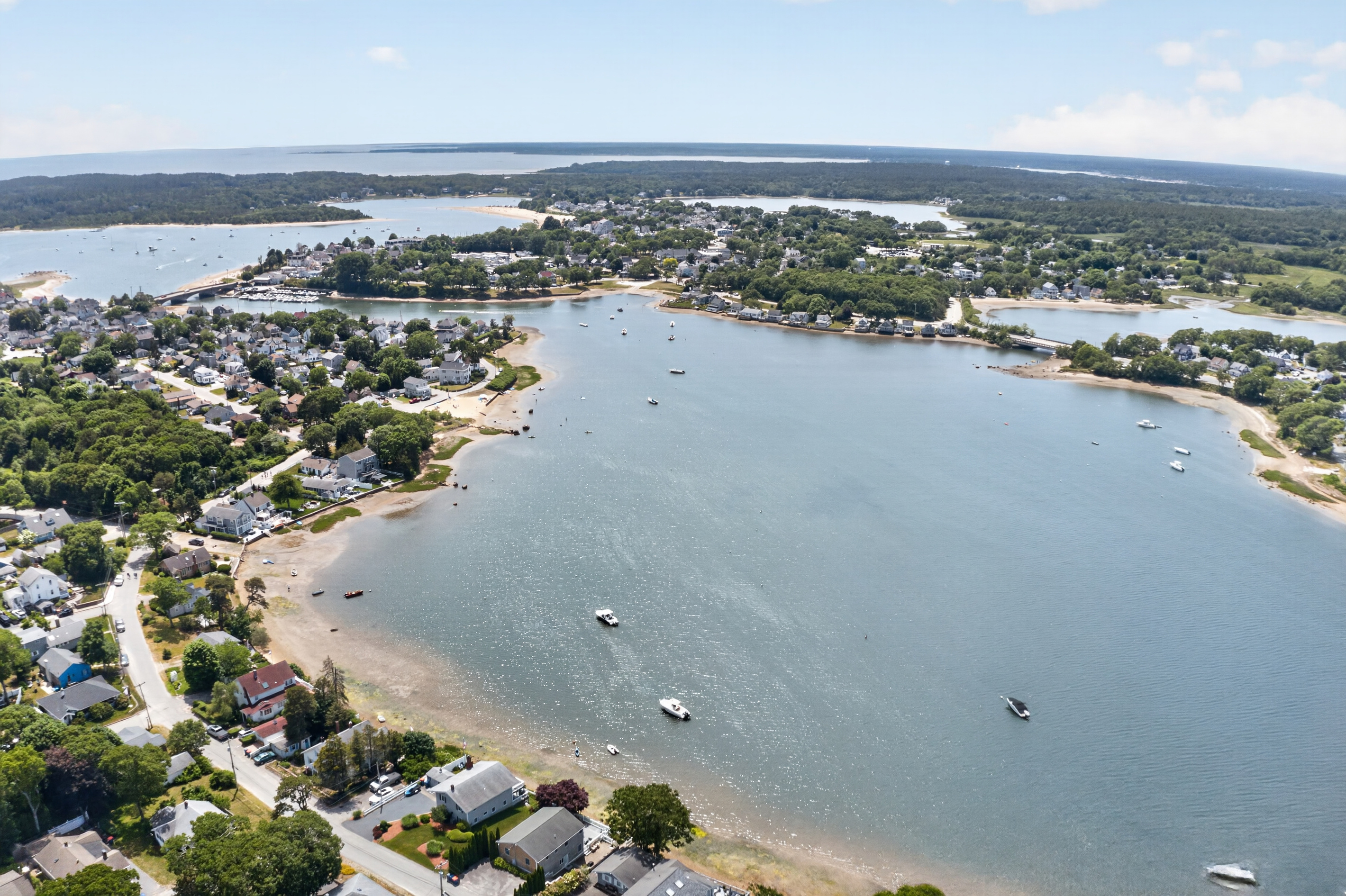 Sweeping aerial view of the bay and surrounding coastline, showcasing the area's natural beauty.