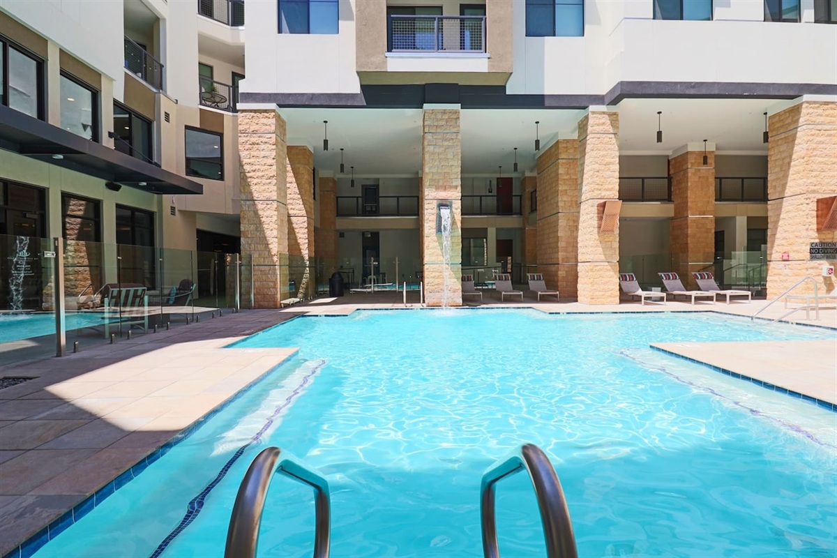 - Cool off in a bright pool surrounded by sleek architecture and sunshine   - Lounge comfortably on poolside chairs for a refreshing outdoor escape   - A perfect spot to swim, relax, or soak up peaceful vacation vibes