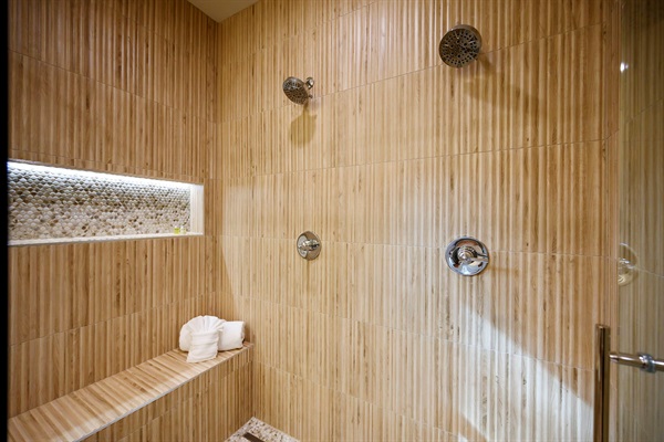 A spacious walk-in shower with calming tones and a cozy bench for the ultimate relaxation. 🤍🌿