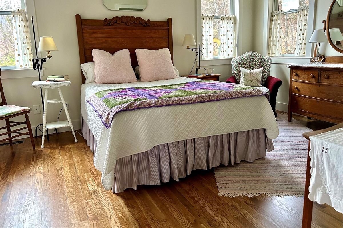 A collection of vintage furniture, antique quilt & rag rug add to the comfy feel