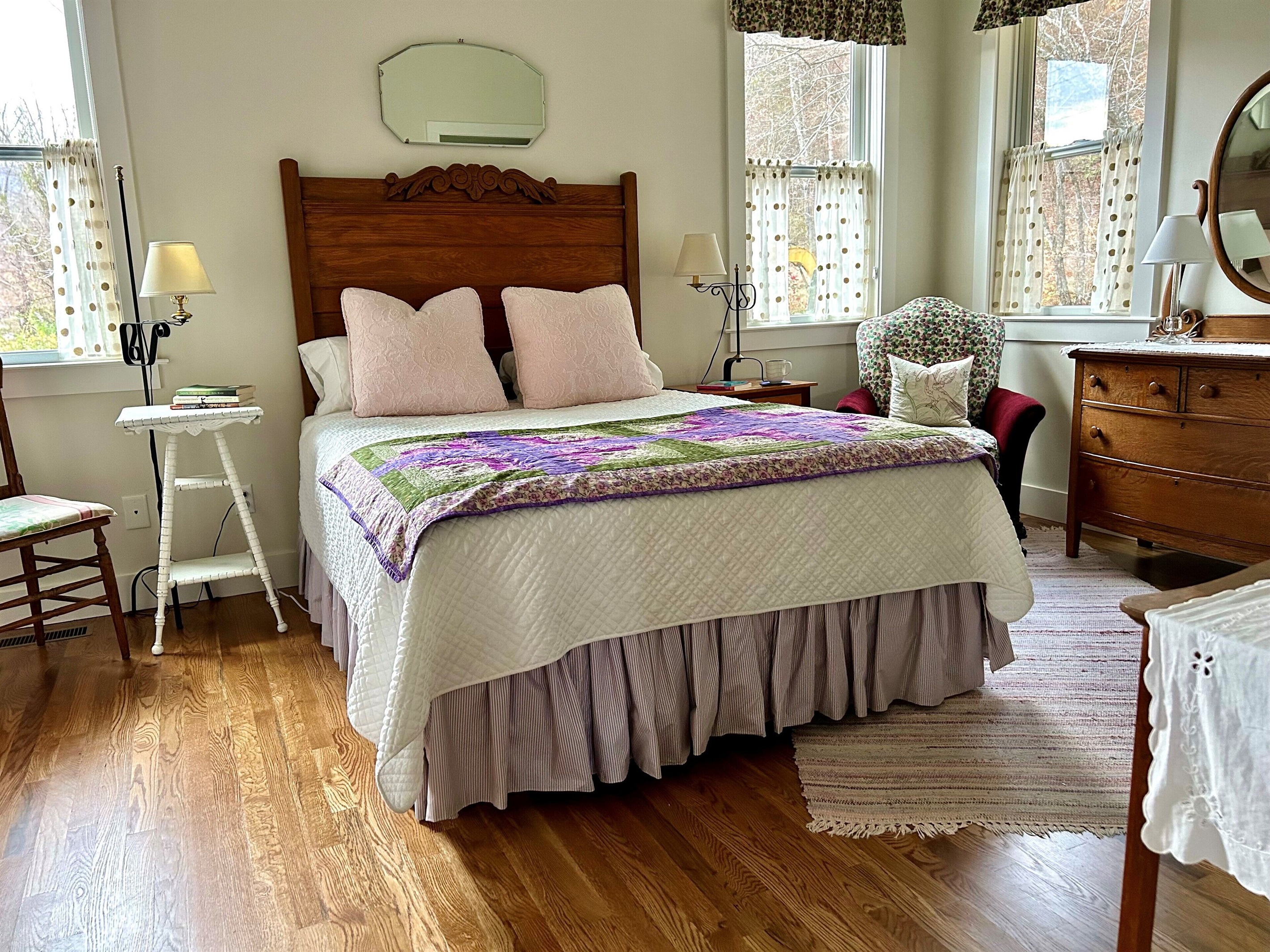 A collection of vintage furniture, antique quilt & rag rug add to the comfy feel