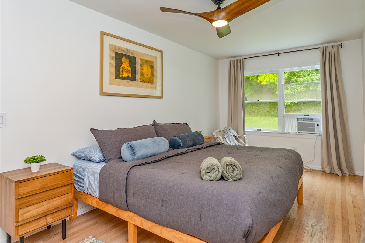 Relax in this serene king bedroom with plush bedding—your perfect escape after a day of Finger Lakes adventure