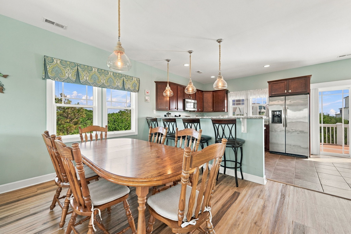 Gather around the dining table for family meals, with additional breakfast bar seating just steps away