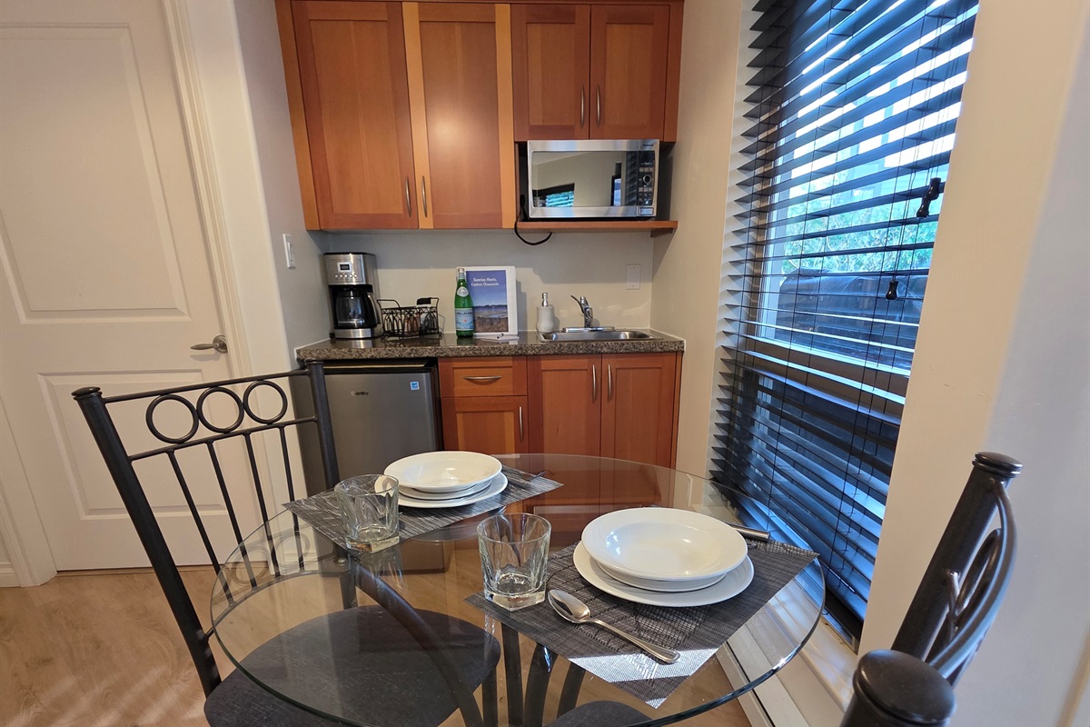 Unit B. Modern and spacious kitchenette area including coffee bar. Enjoy your coffee on glass table or covered patio. Tons of room and open concept. Weber BBQ on covered patio as well!