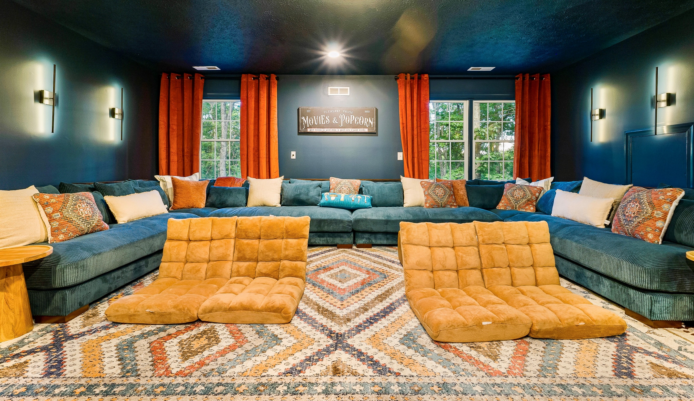 Plush sectionals, floor loungers, and theater-style lighting make this the ultimate space for family movie marathons.