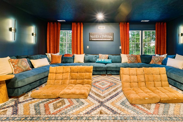 Plush sectionals, floor loungers, and theater-style lighting make this the ultimate space for family movie marathons.